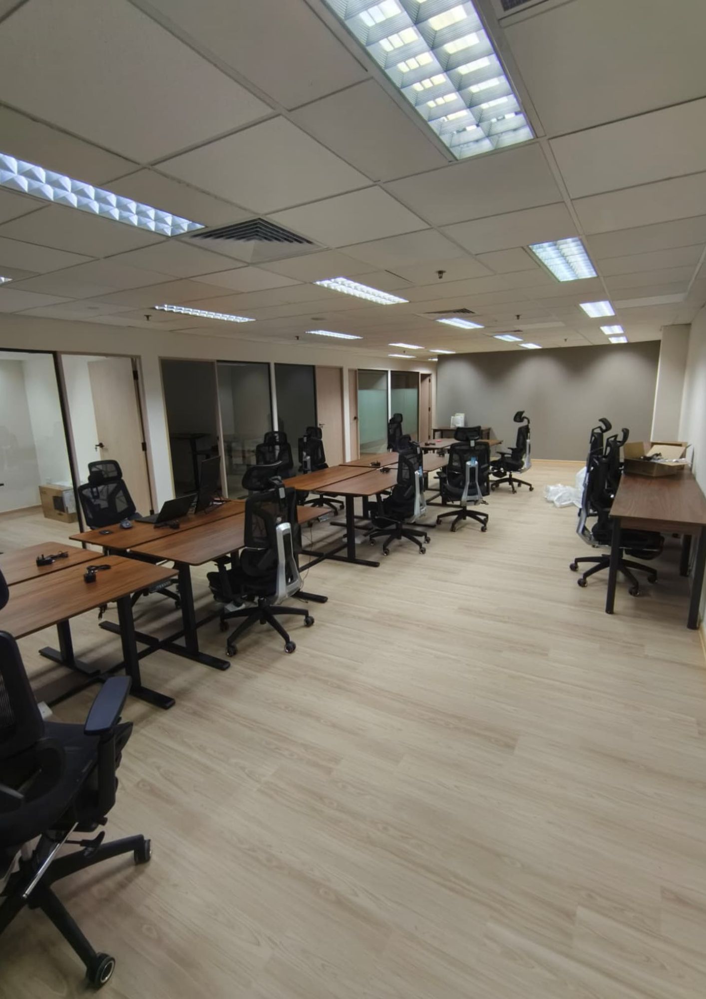 Multiple workstations with timber desks and mesh chairs at Fortress Law Corporation