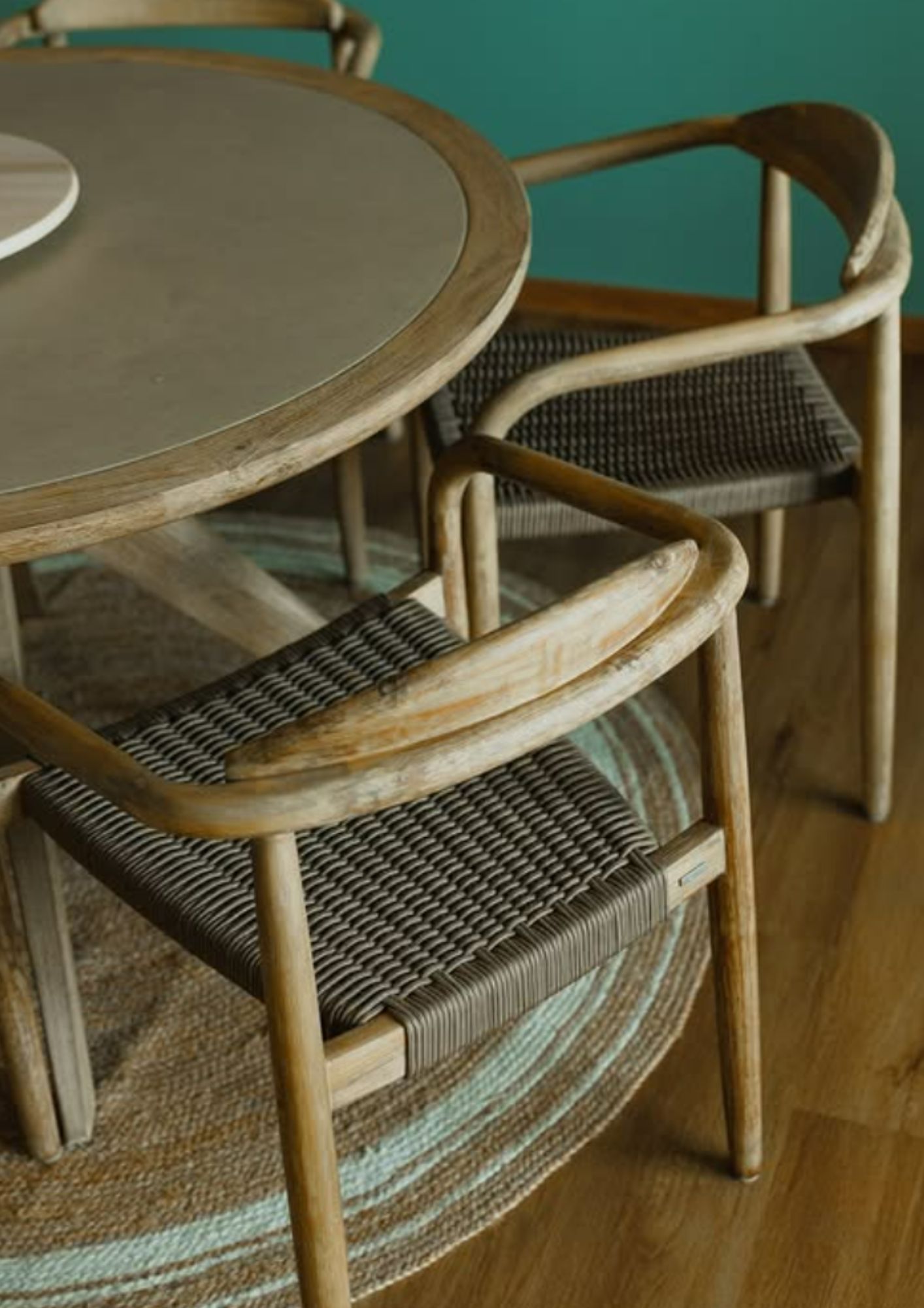 Round dining table with woven rattan chairs on jute rug in Telok Blangah Heights HDB